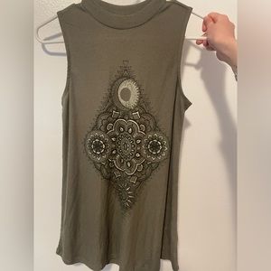 Maurice’s dark green high neck shirt with mandala design
